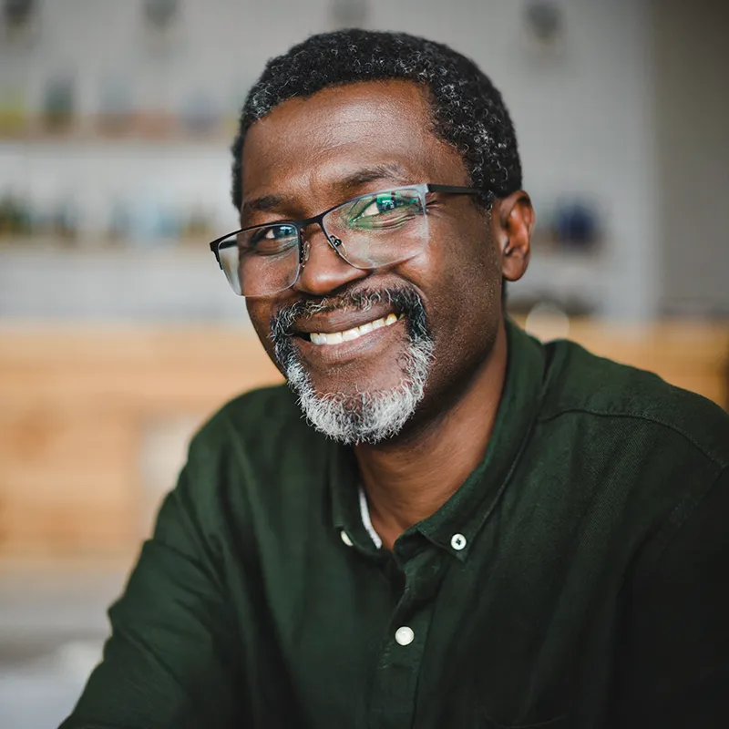 Middle-aged man wearing glasses and smiling